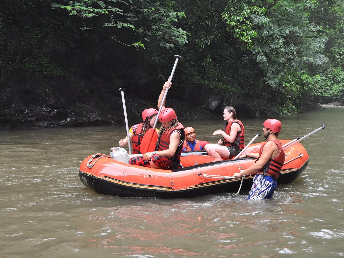 Rafting group paddling through a class three rapid on the Ayung river in the Ubud jungle gorge