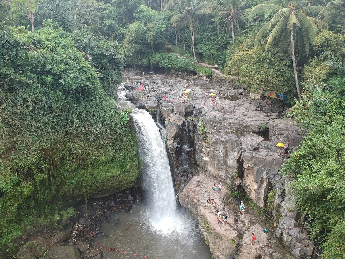 Tegenungan waterfall near Ubud Bali with a wide curtain of water and a swimming pool below